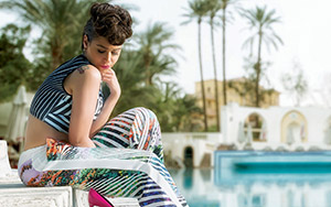 Egyptian actress, Menna Shalabi posing besides a pool